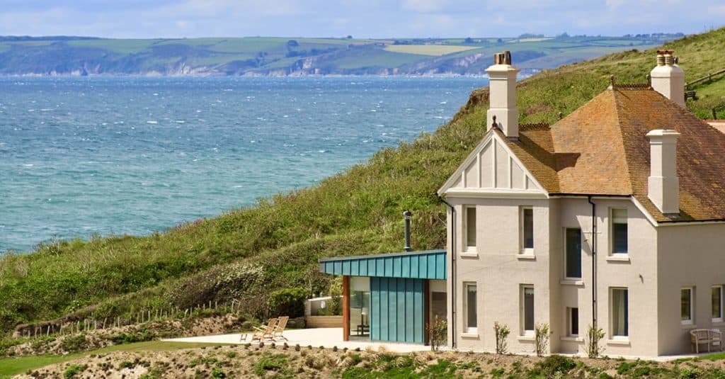 Large extended house overlooking coastline at Hope Cove with contemporary garden room