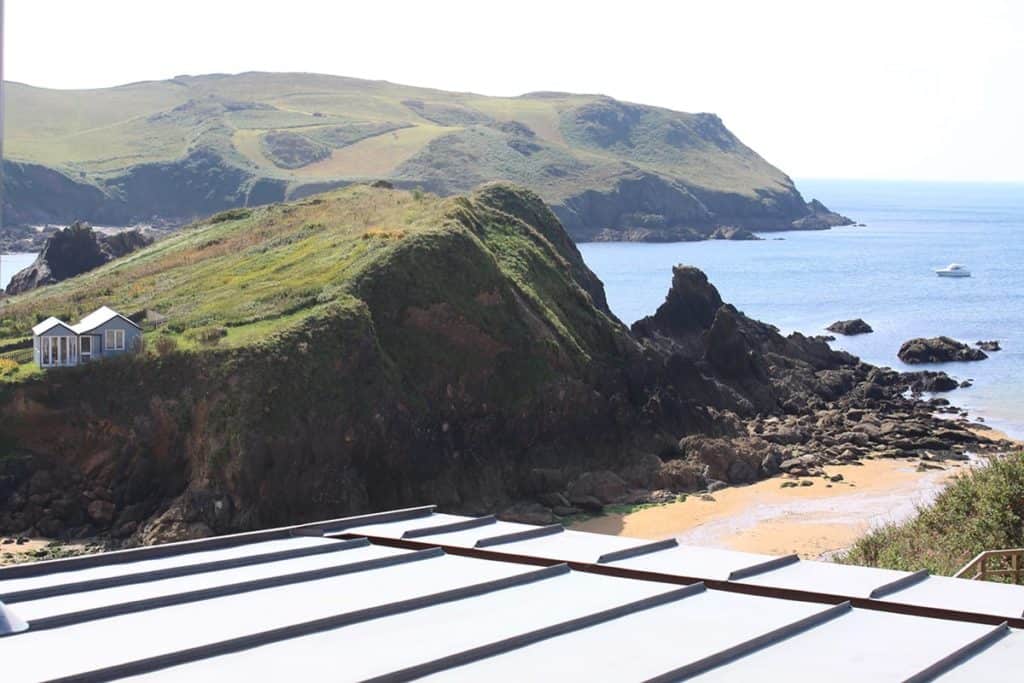 Copper roof of garden room looking out to cliffs and the sea at Hope Cove