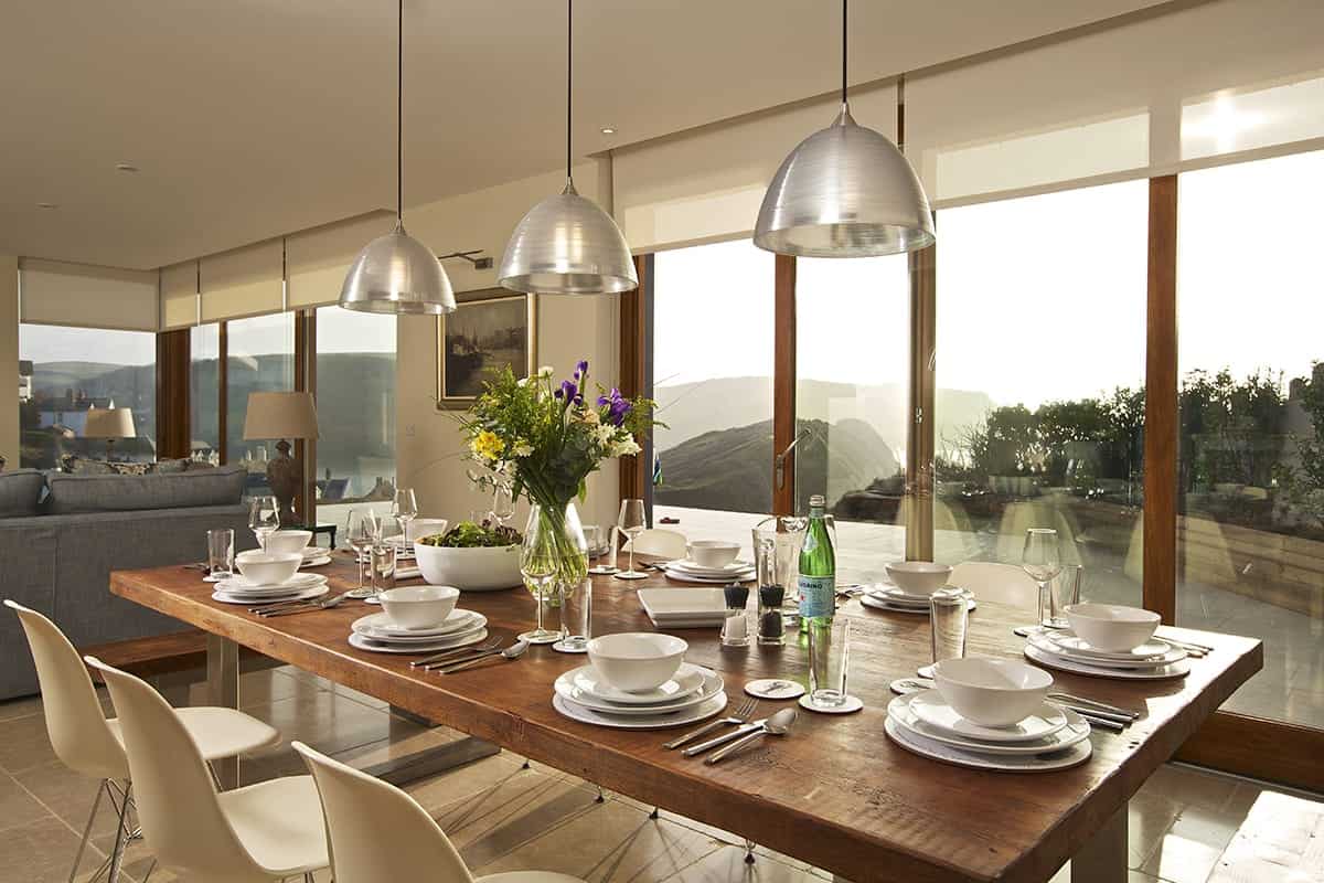 Large table set out in contemporary extention overlooking Devon coast