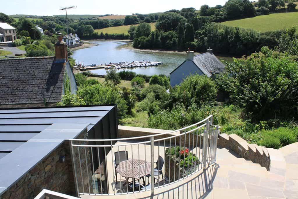 Zinc roof with steps leading down to back of cottage overlooking South Pool Estuary