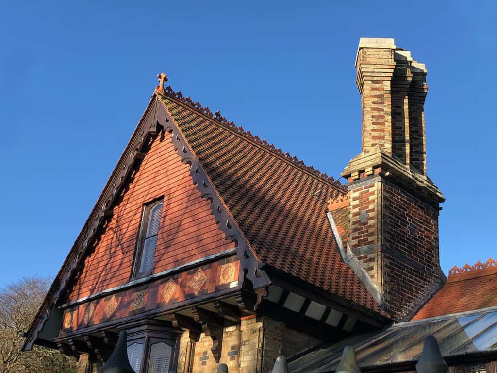 Victorian Gatehouse with tall chimneys and clay roof tiles