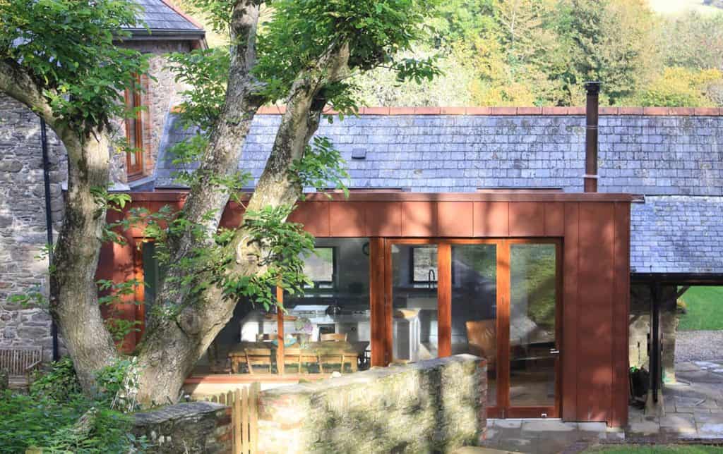 Old tree infront of contemporary dining room
