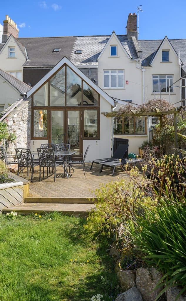 Garden looking towards a white Plymouth Victorian Townhouse extention