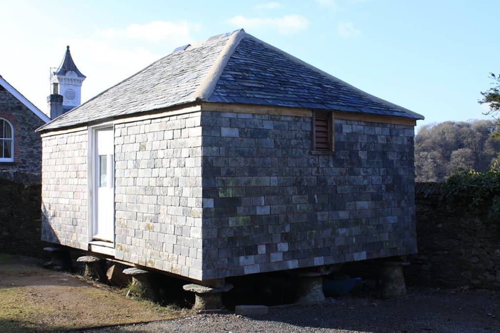 Grain store covered in grey local slate standing on stilts
