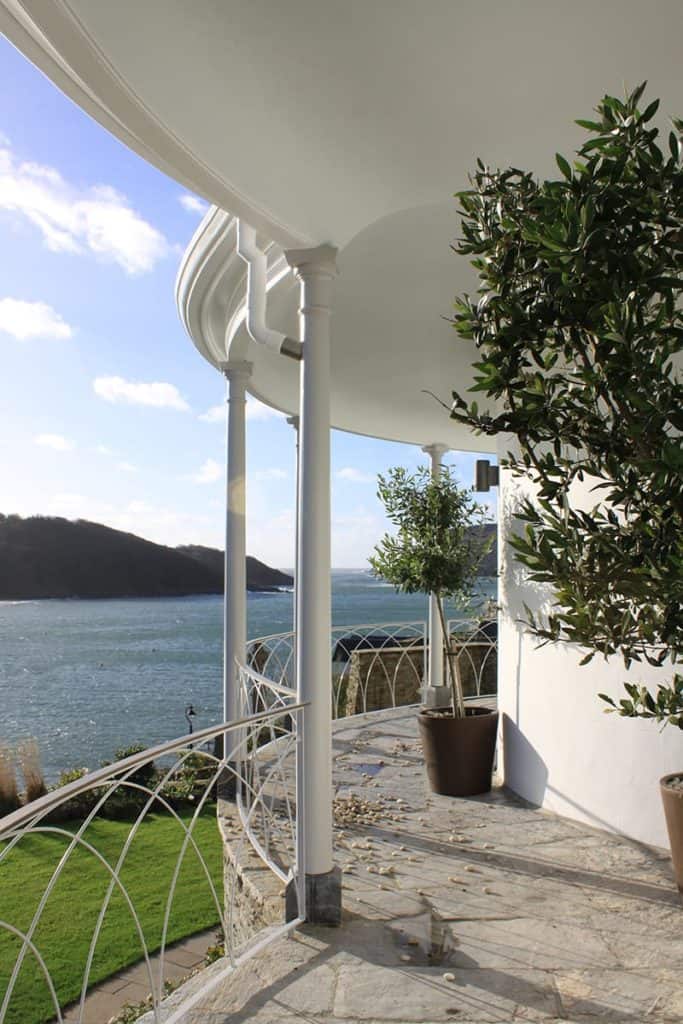 White Georgian villa colonade overlooking Salcome estuary