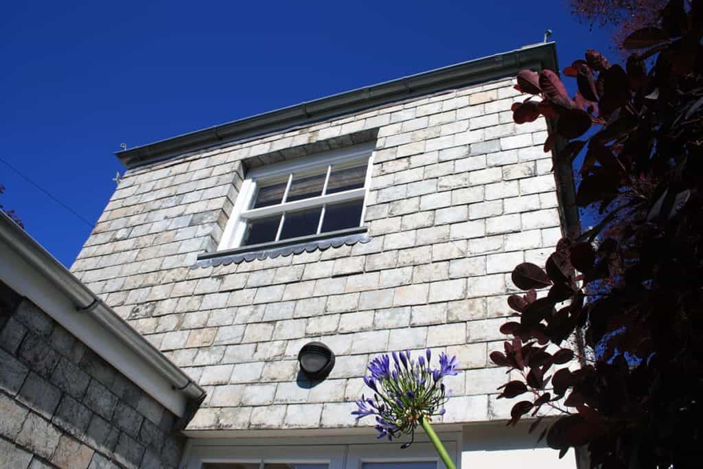 Traditional exterior of Geogian house pediment with delabole slate hanging on exterior walls
