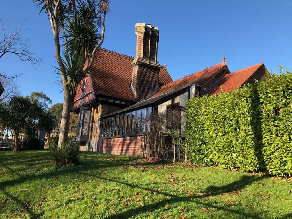 Victorian Gatehouse with long side building overlooking park