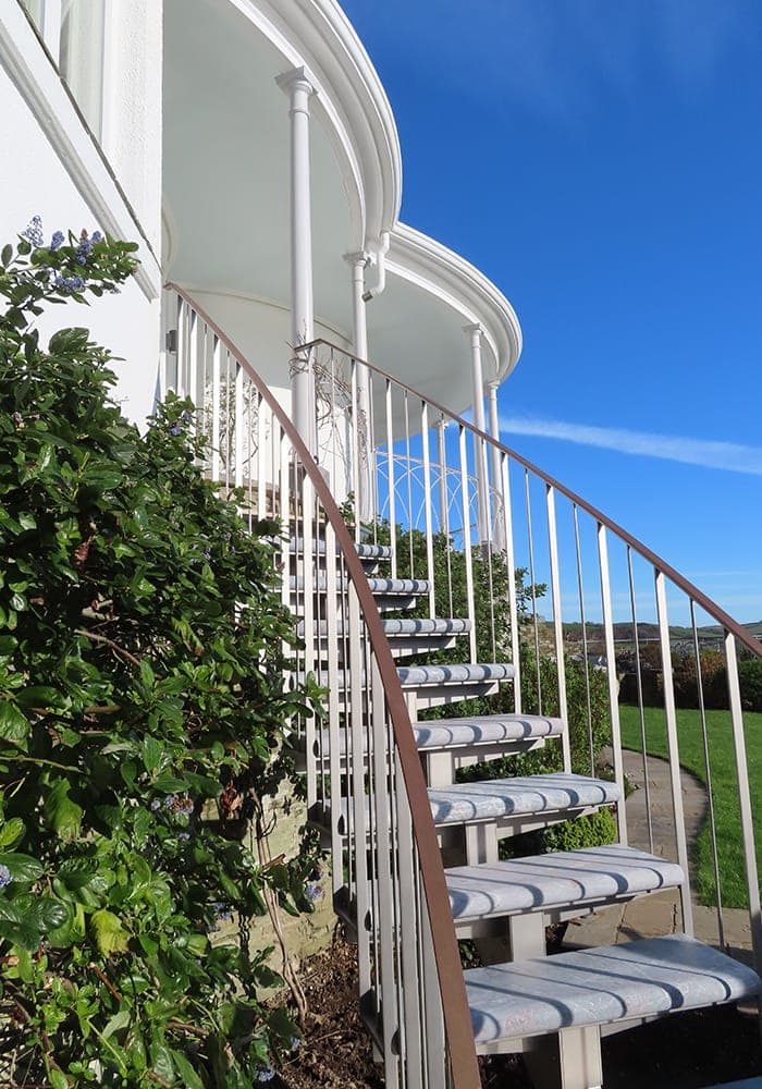 Curved stone steps leading up to Victorian House in Salcombe